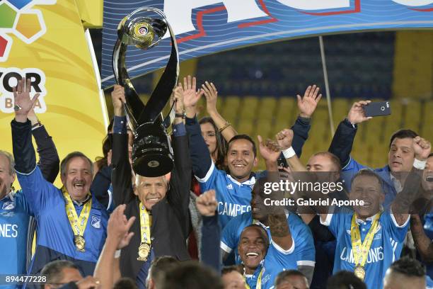 Miguel Angel Russo coach of Millonarios lifts the champions trophy to celebrate after winning the second leg match between Millonarios and Santa Fe...