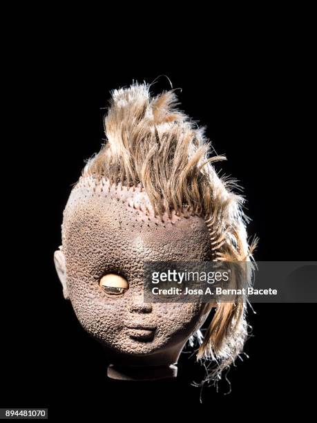 head of an old wrist broken with blond hair, torn and degraded by the fire, on a black background. spain - creepy monsters from the past stock pictures, royalty-free photos & images