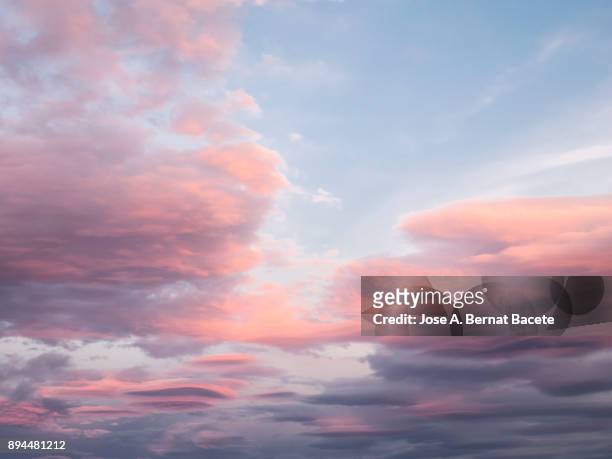 full frame of the low angle view of clouds in sky during sunset with pink and fuchsia clouds. valencian community, spain - romantic sky stock pictures, royalty-free photos & images