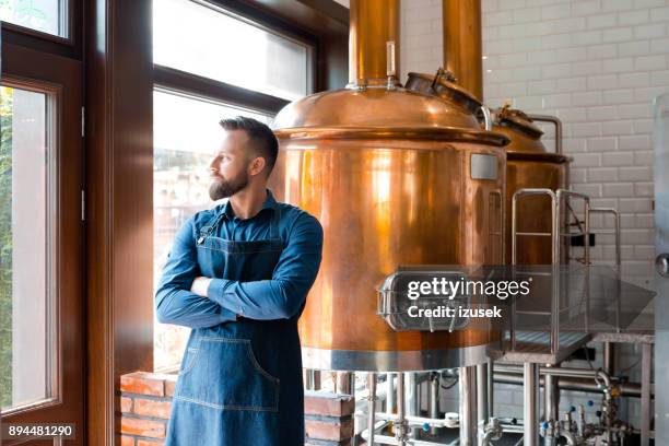 master brewer standing in micro brewery - microbrewery stock pictures, royalty-free photos & images