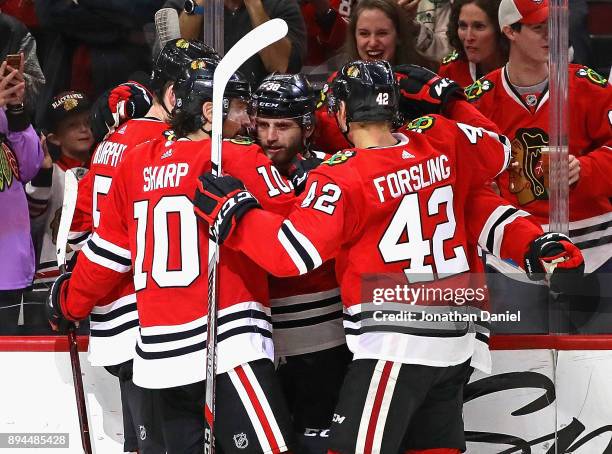 Connor Murphy, Patrick Sharp and Gustav Forsling of the Chicago Blackhawks congratulate Ryan Hartman after Hartman scored a third period goal against...