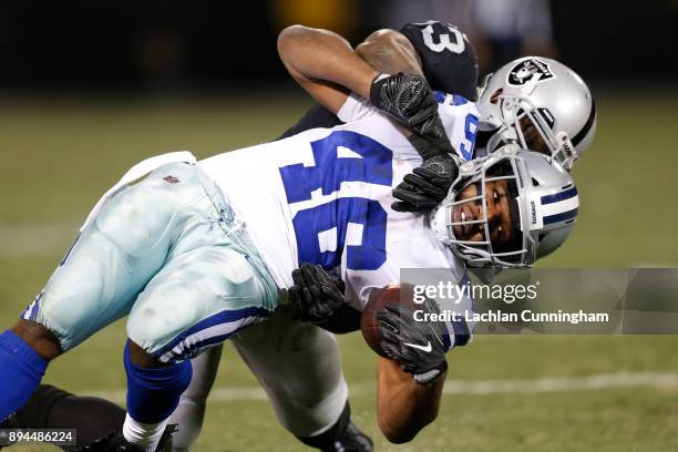 Alfred Morris of the Dallas Cowboys is tackled by NaVorro Bowman of the Oakland Raiders during their NFL game at Oakland-Alameda County Coliseum on...