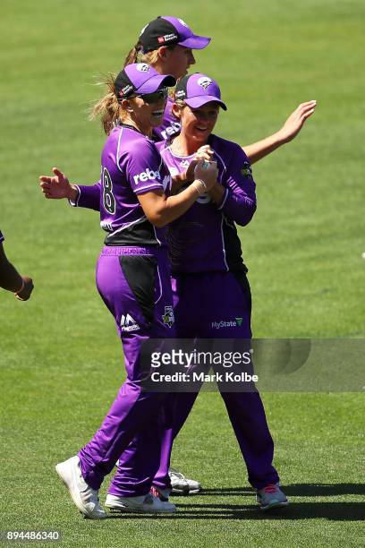 Lauren Winfield and Corinne Hall of the Hurricanes celebrate the wicket of Dane Van Niekerk of the Sixers during the Women's Big Bash League match...