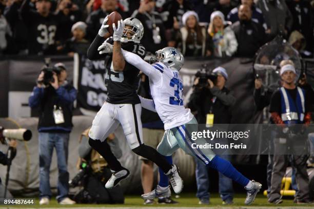 Michael Crabtree of the Oakland Raiders catches a pass for a touchdown against the Dallas Cowboys during their NFL game at Oakland-Alameda County...