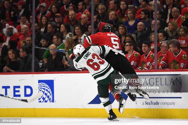 Minnesota Wild left wing Tyler Ennis checks Chicago Blackhawks defenseman Connor Murphy during the first period during a game between the Chicago...