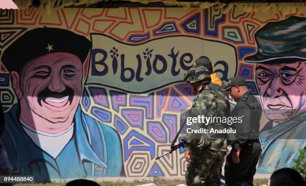 Member of Colombian security forces stand guard during a graduation ceremony after former members of Common Alternative Revolutionary Force completed...