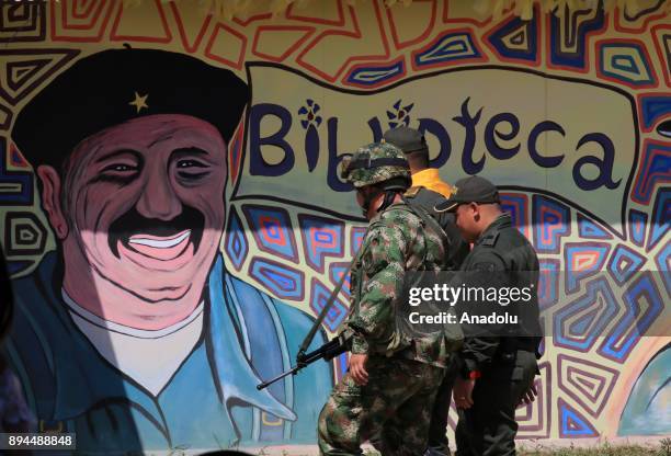Member of Colombian security forces stand guard during a graduation ceremony after former members of Common Alternative Revolutionary Force completed...