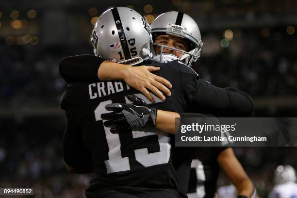 Michael Crabtree of the Oakland Raiders celebrates with Derek Carr after a two-yard touchdown catch against the Dallas Cowboys during their NFL game...