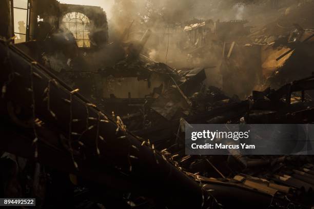 Heat and smoke rises from the rubble of a home that was destroyed by the Thomas Fire on December 17, 2017 in Montecito, California.