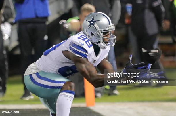 Dallas Cowboys wide receiver Dez Bryant catches a football from a fan after quarterback Dak Prescott scores on a keeper in the third quarter against...