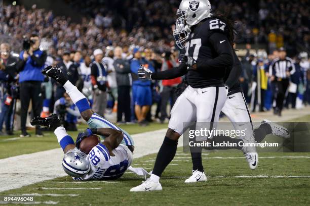 Dez Bryant of the Dallas Cowboys makes a catch at the four-yard line against the Oakland Raiders during their NFL game at Oakland-Alameda County...