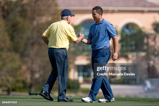 Jack Nicklaus and his grandson Gary Nicklaus Jr. Shake hands on the 18th green after the final round of the PNC Father/Son Challenge at The...