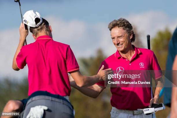 Bernhard and Jason Langer of Germany celebrate on the 18th green after their final round of the PNC Father/Son Challenge at The Ritz-Carlton Golf...