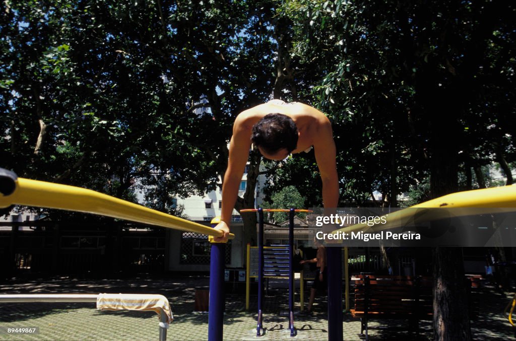 A gymnast practises bars in a public park in Shanghai.