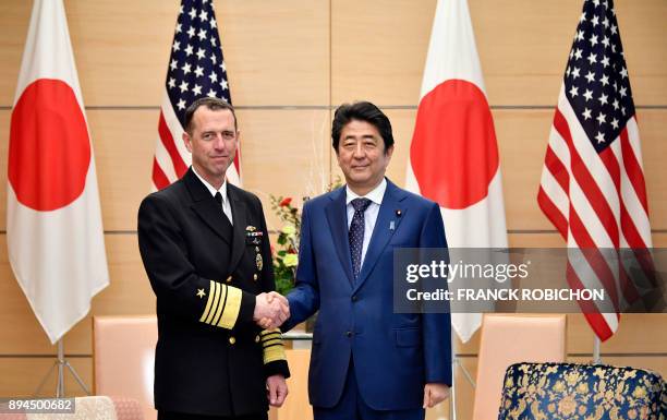 Admiral John Richardson , chief of US Naval Operations, is welcomed by Japan's Prime Minister Shinzo Abe before their meeting at the prime minister's...