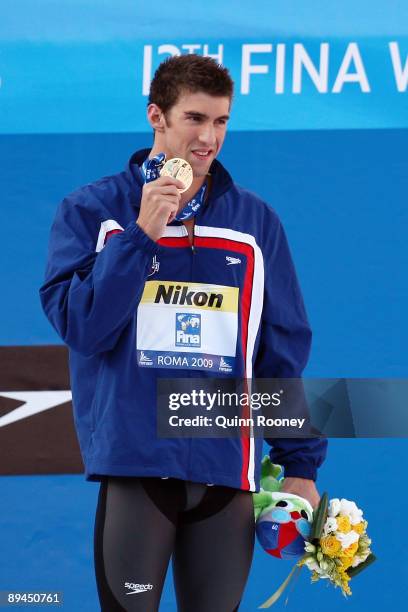 Michael Phelps of United States receives the gold medal during the medal ceremony for the Men's 200m Butterfly Final during the 13th FINA World...