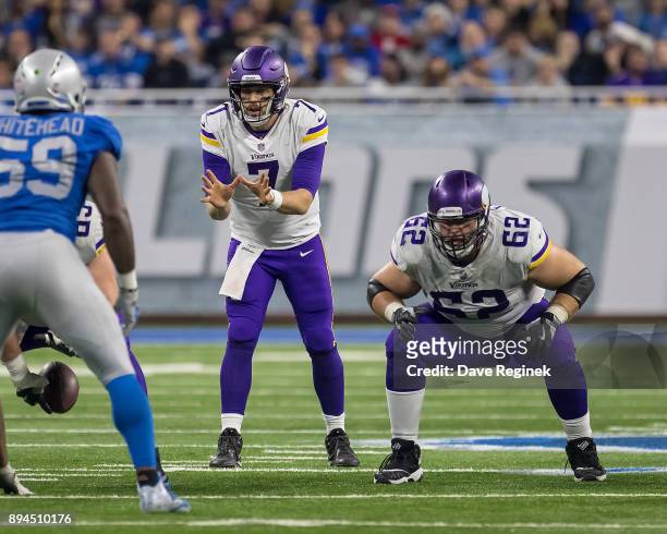 Nick Easton and Case Keenum of the Minnesota Vikings gets set for the play against the Detroit Lions during an NFL game at Ford Field on November 23,...