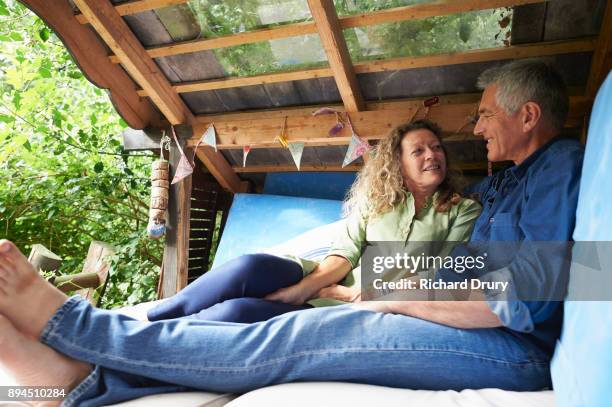 couple sitting in treehouse - tree house stock pictures, royalty-free photos & images