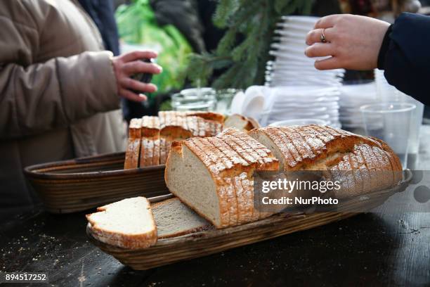 Loaves of bread and warm meals are being distributed during the Christmas Eve Supper for the homeless and poor at the Main Square in Krakow, Poland...