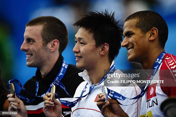 Gold medalist China's Zhang Lin , silver medalist Tunisia's Oussama Mellouli and Canada's Ryan Cochrane celebrate on the podium of the men's 800m...