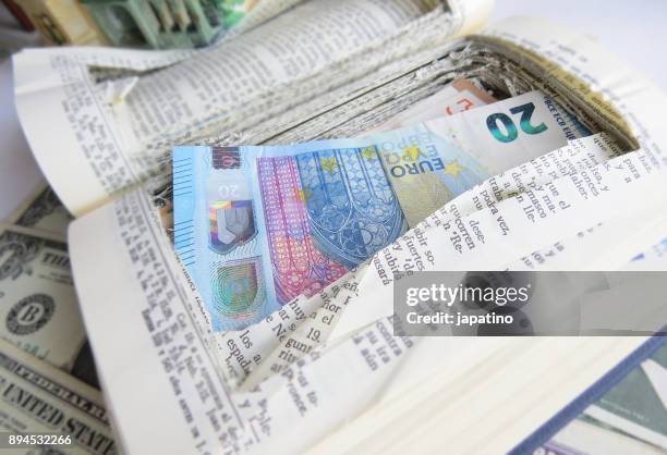money saved in a book - verstopt stockfoto's en -beelden