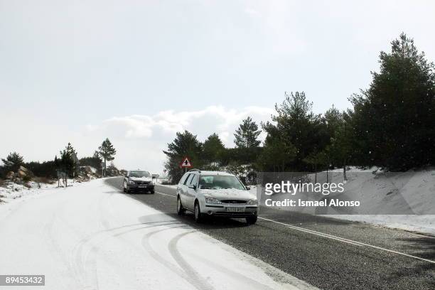 Navacerrada mountain pass road covered with snow after the storm.