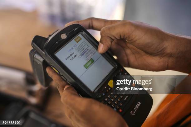 An employee processes data from a transmitter device by DMICDC Logistics Data Services Ltd., a joint venture between NEC Corp. And DMIC Trust, at the...