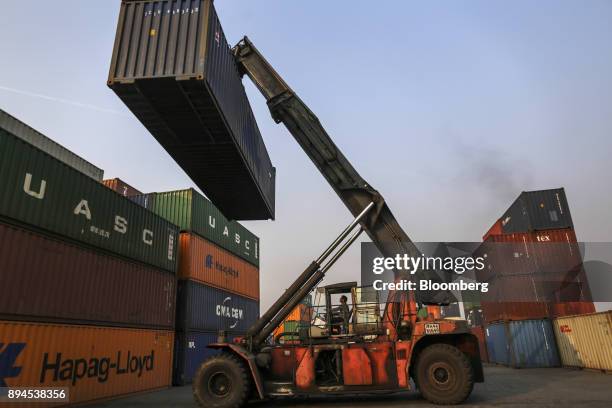 Reach stacker moves a shipping container at the Jawaharlal Nehru Port, operated by Jawaharlal Nehru Port Trust , in Navi Mumbai, Maharashtra, India,...