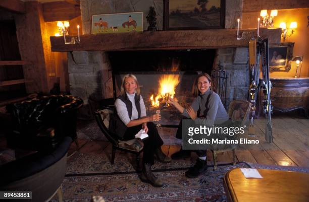 Patagonia Argentina. Argentina Two women drinking something next to the fire.