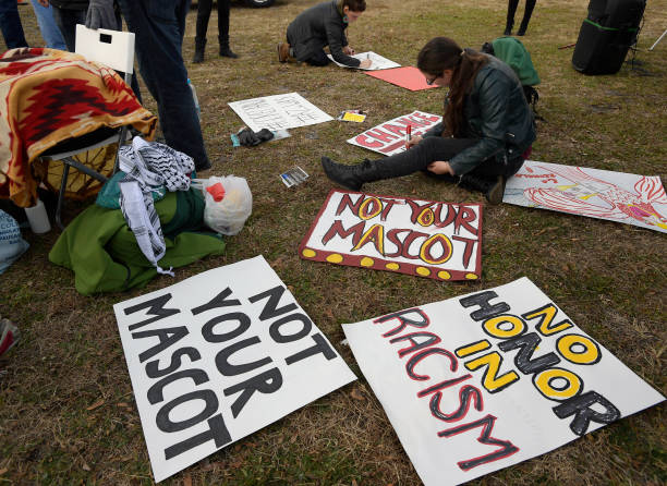 Leah Muskin-Pierret of Washington DC works on signs as part of a Native Americans protest against the Redskins team name before the Washington...