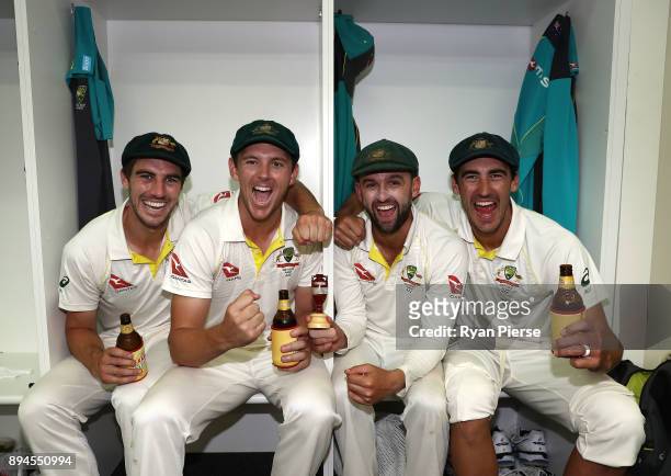 Pat Cummins, Josh Hazlewood, Nathan Lyon and Mitchell Starc of Australia celebrate in the changerooms after Australia regained the Ashes during day...