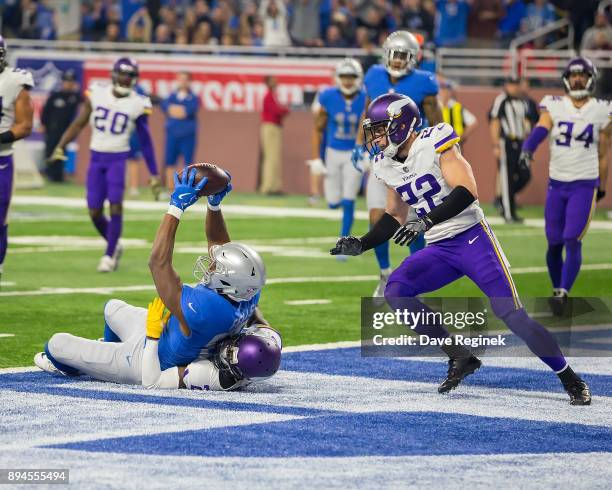 Darren Fells of the Detroit Lions appears to score a touchdown over Tramaine Brock of the Minnesota Vikings that was later overturned on a review...