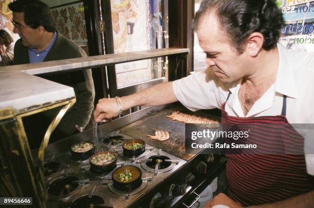 La Casa del Abuelo bar, Madrid Cook preparing 'tapas' in the kitchen of the bar