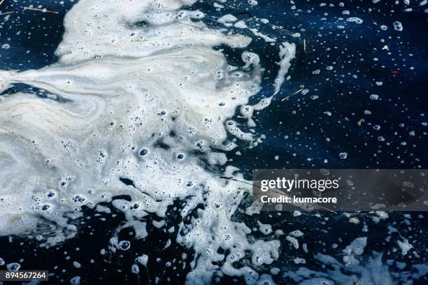 dirty discharge surface of the water - water pollution stock pictures, royalty-free photos & images