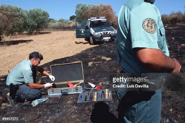 Spain. Civil Guards of the Nature Protection Service working with a burnt land in a field.
