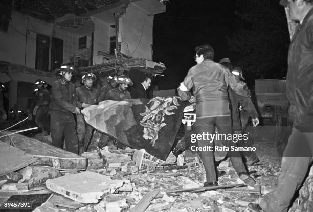 April 12, 1985. Madrid Terrorist attack against the restaurant 'El Descanso' Firemen and members of the Red Cross carry a dead man in a stretcher....