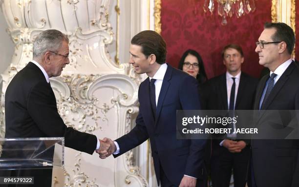 Austrian President Alexander Van der Bellen shakes hands with Austrian Chancellor of the conservative People's Party Sebastian Kurz next to...