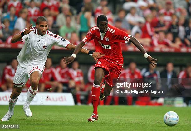Saer Sene of Bayern Muenchen and Oguchi Onyewu of AC Milan challenge for the ball during the Audi Cup tournament semi final match between Bayern...