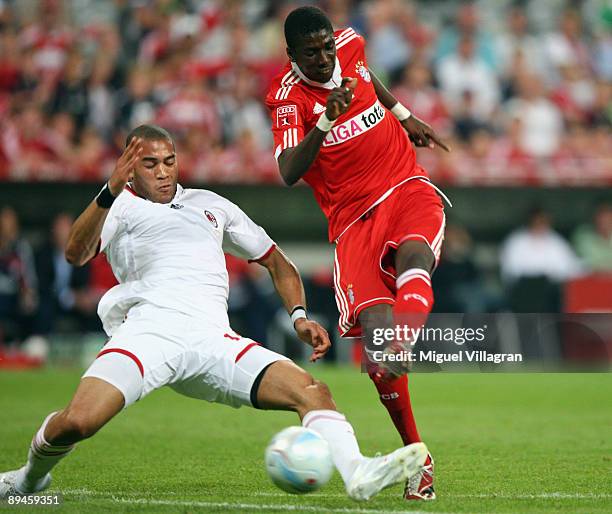 Saer Sene of Bayern Muenchen scores his first goal against Oguchi Onyewu of AC Milan during the Audi Cup tournament semi final match between Bayern...