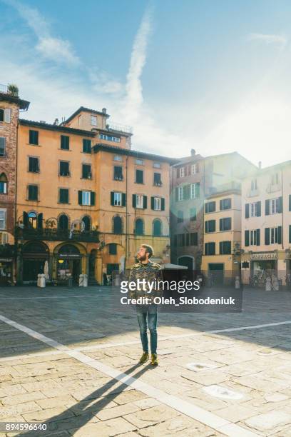 man walking in lucca, italy - lucca italy stock pictures, royalty-free photos & images