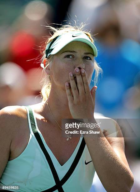 Maria Sharapova of Russia blows kisses to the crowd after beating Nadia Petrova of Russia on Day 3 of the Bank of the West Classic at Stanford...