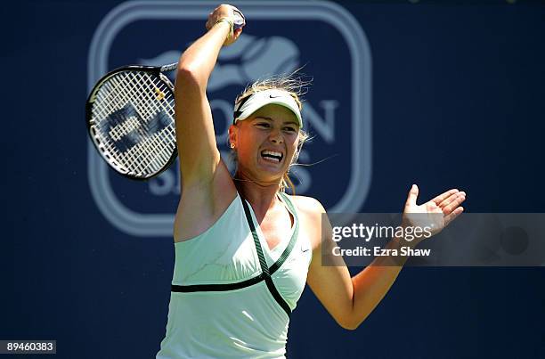 Maria Sharapova of Russia returns a shot to Nadia Petrova of Russia on Day 3 of the Bank of the West Classic at Stanford University on July 29, 2009...