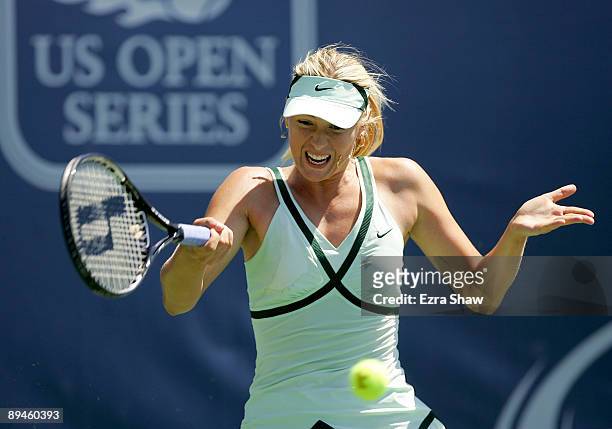 Maria Sharapova of Russia returns a shot to Nadia Petrova of Russia on Day 3 of the Bank of the West Classic at Stanford University on July 29, 2009...