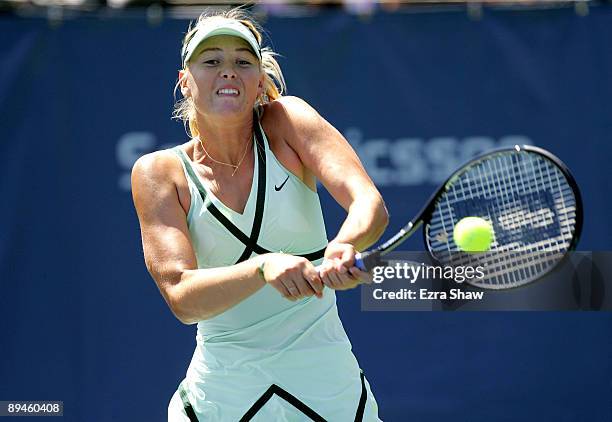 Maria Sharapova of Russia returns a shot to Nadia Petrova of Russia on Day 3 of the Bank of the West Classic at Stanford University on July 29, 2009...