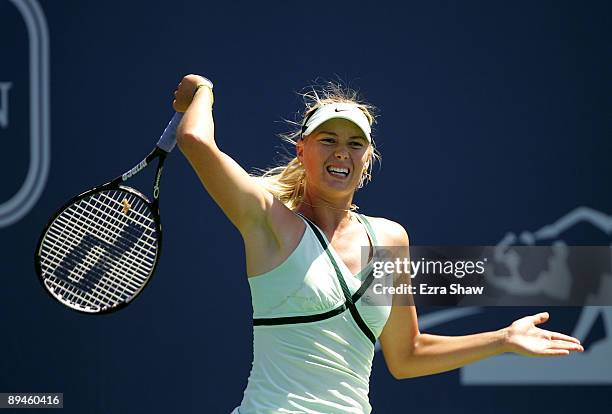 Maria Sharapova of Russia returns a shot to Nadia Petrova of Russia on Day 3 of the Bank of the West Classic at Stanford University on July 29, 2009...