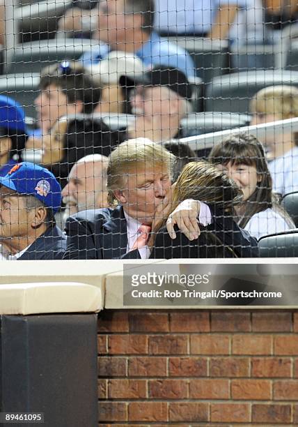 Donald Trump and wife Melania Trump share a kiss during a game between the Los Angeles Dodgers and the New York Mets on July 8, 2009 at Citi Field in...