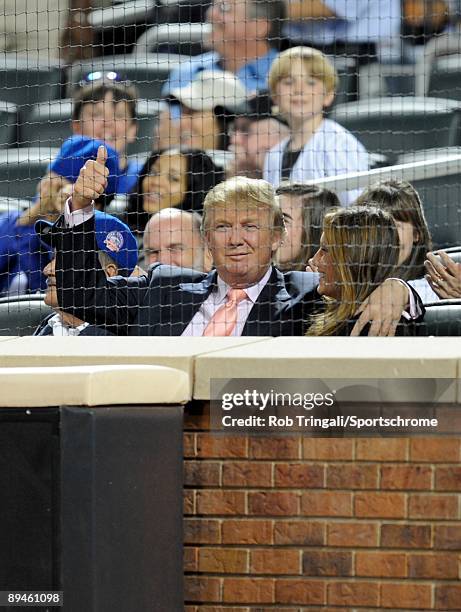 Donald Trump and wife Melania Trump share a kiss during a game between the Los Angeles Dodgers and the New York Mets on July 8, 2009 at Citi Field in...