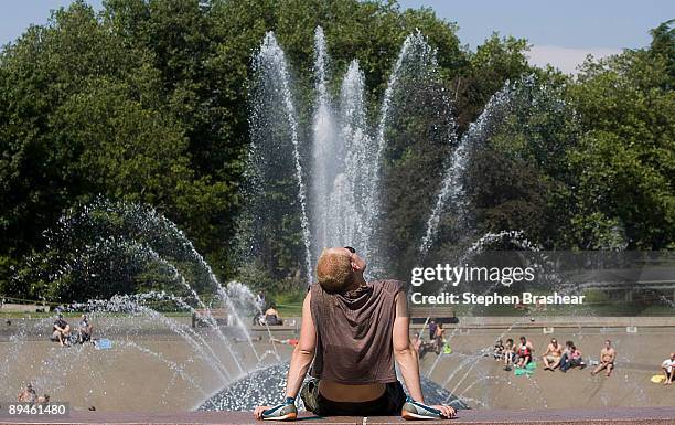 Jeremy Behrens of Chicago, Illinois dries off in the sun after cooling off in the International Fountain at the Seattle Center July 29, 2009 in...