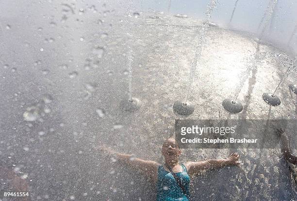 Rebecca Brose of Seattle leans against the International Fountain to cool off at the Seattle Center July 29, 2009 in Seattle, Washington. The...