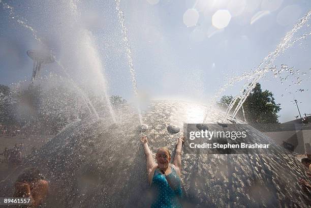 Rebecca Brose of Seattle leans against the International Fountain to cool off at the Seattle Center July 29, 2009 in Seattle, Washington. The...